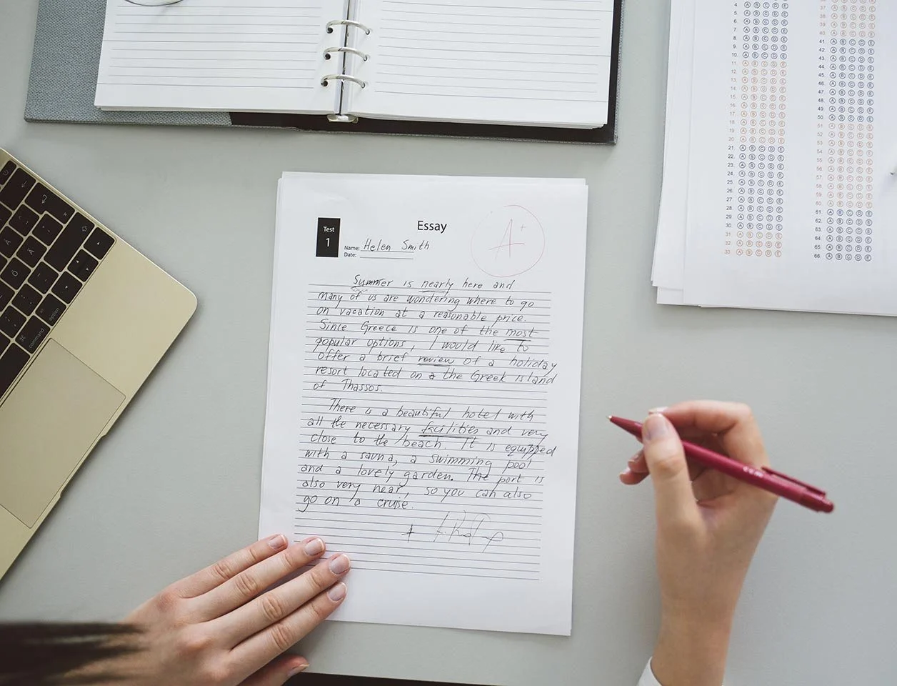 A handwritten essay draft on a desk