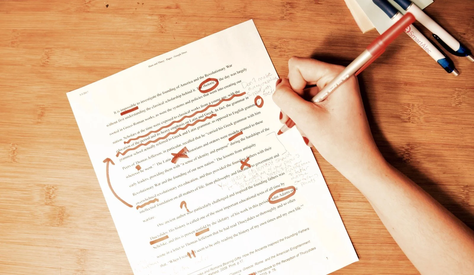 An essay draft marked up with a red pen